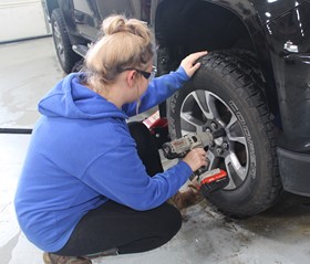 person changing car tire